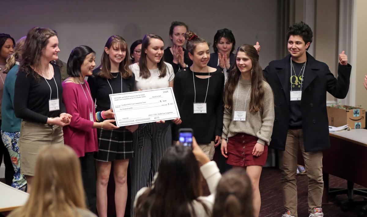  Andrew Shurtleff/The Daily Progress | Monticello High School Health and Medical Sciences Academy students hold up a $500 check for winning a global health case competition Tuesday 19 March at the Darden School of Business. Students were asked to find a solution for the Global Health crisis in the Appalachian region. The event was sponsored by the UVA Center for Global Health.